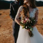 Bride,And,Groom,Dressed,Elegant,In,Their,Wedding,Gowns,Holding