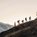 Group,Of,Tourists,Silhouettes,Walks,With,Backpacks,In,Mountains